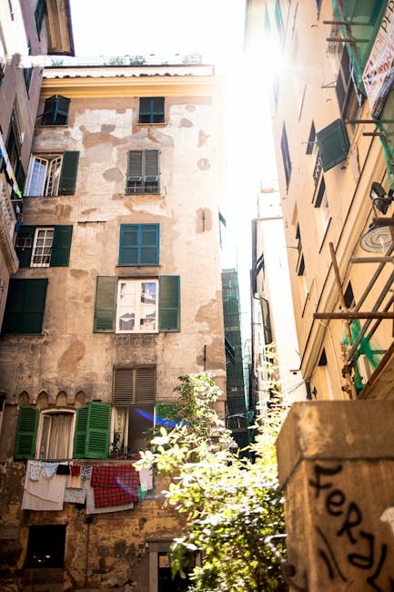 Sunlit view of historic buildings in Genova, capturing architectural charm and urban dynamic.