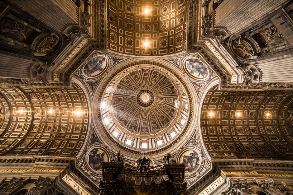 Intricate view of St. Peter's Basilica's dome, showcasing religious artistry and architectural grandeur.